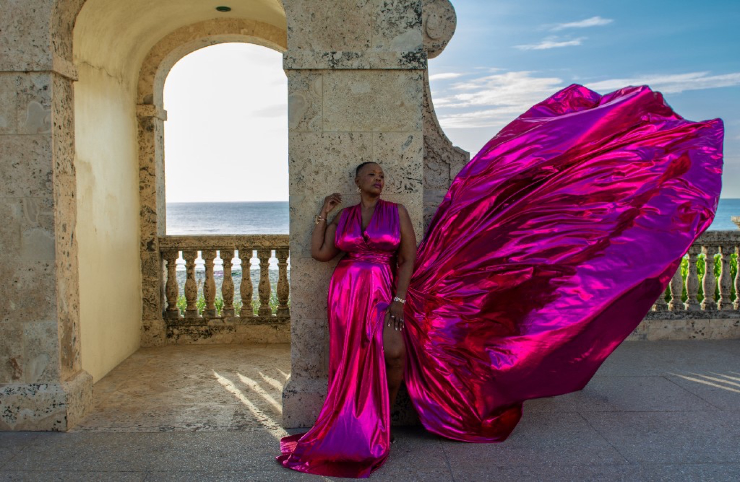 Flying dress photoshoot at the Worth Avenue Clock Tower — metallic magenta gown